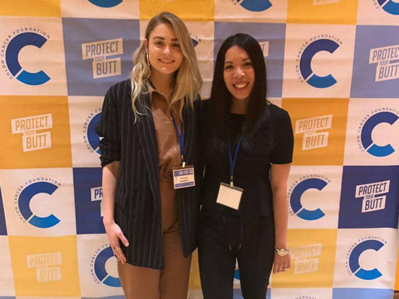 [:fr]Image of two women in front of 'Protect Your Butt' banner[:]