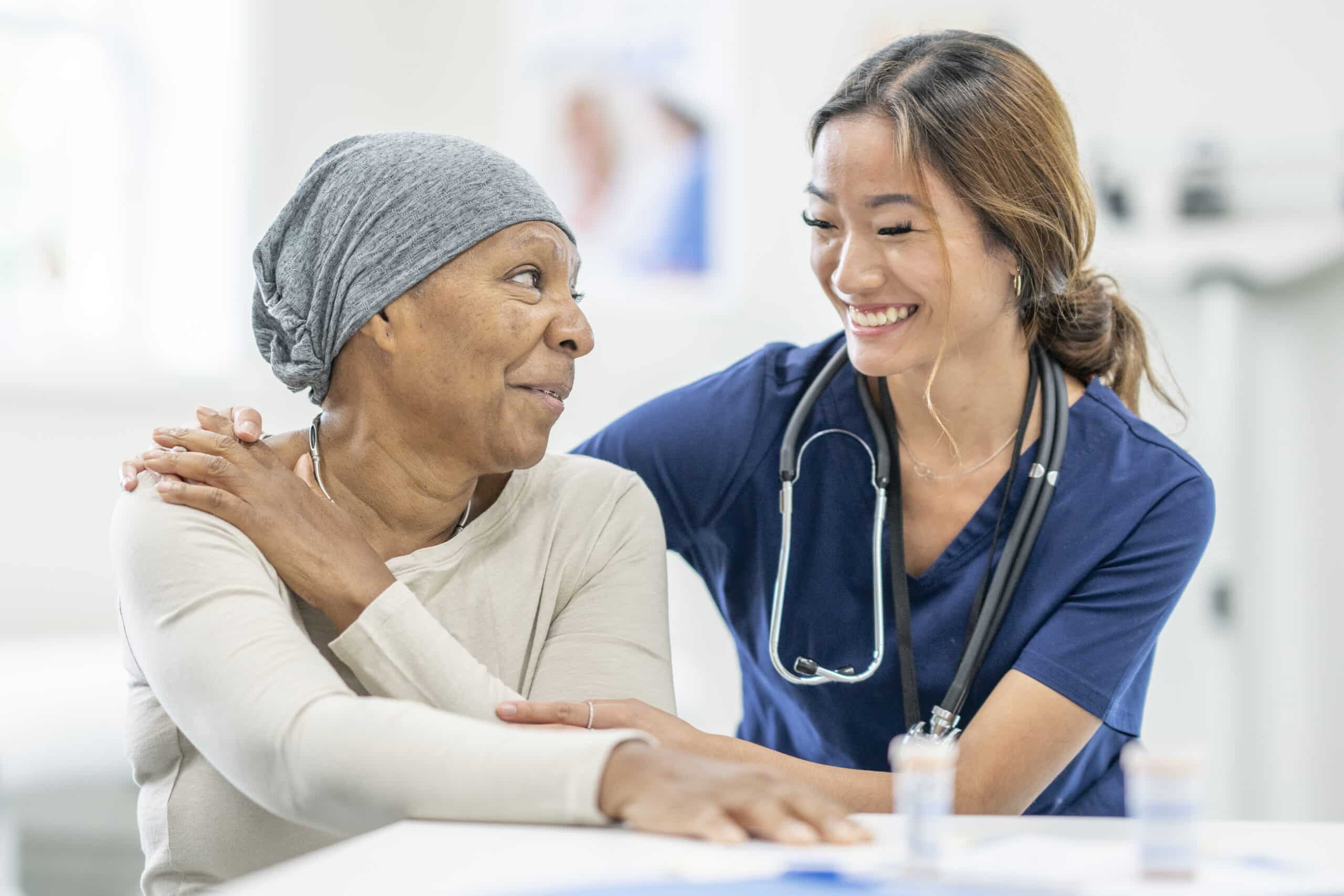 Nurse Comforting a Woman with Cancer Nurse Comforting a Woman with Cancer